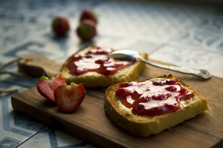 Breakfast sandwich paired with Jam and your favorite fruit